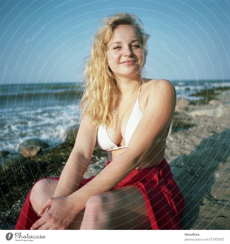 Analogue portrait of a young woman in a bikini on the beach of the Baltic Sea White crest Waves Ocean Red Bikini Beach Hot Beautiful weather evening light