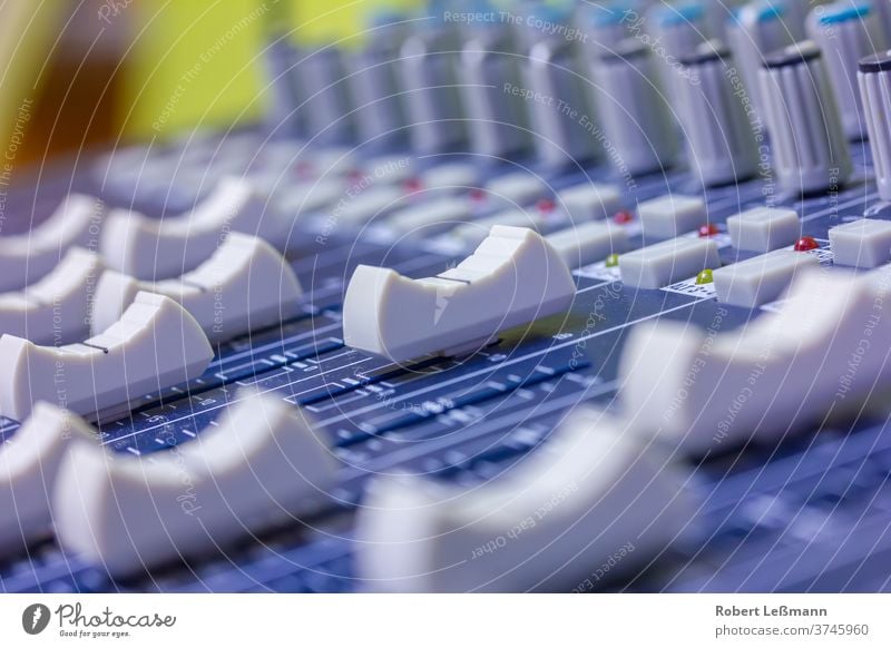 Close-up of a mixing console in a studio mixer Volume Music audio equipment Volume indicator clip power Deflection Volt Switch record Buttons Controller