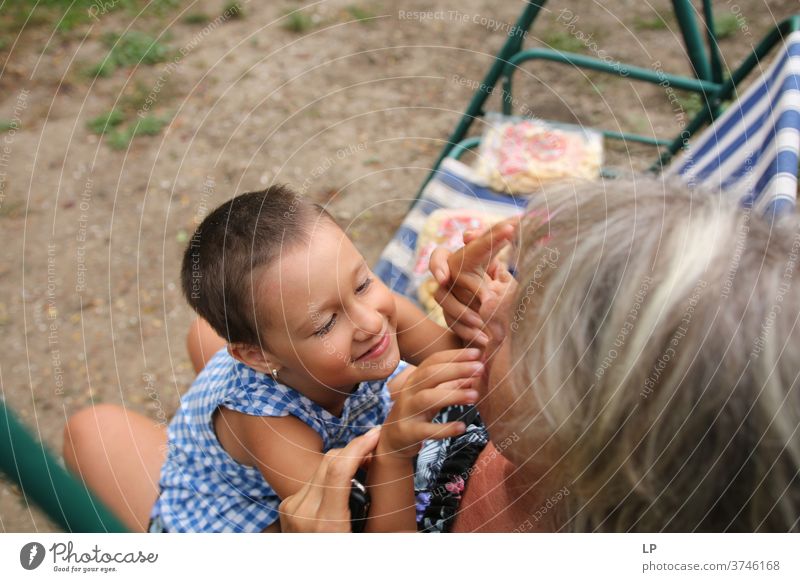 mature woman holding a baby in her arms, playing and laughing Parenting Looking Portrait photograph Exterior shot Communication Funny Independence Contact Peace