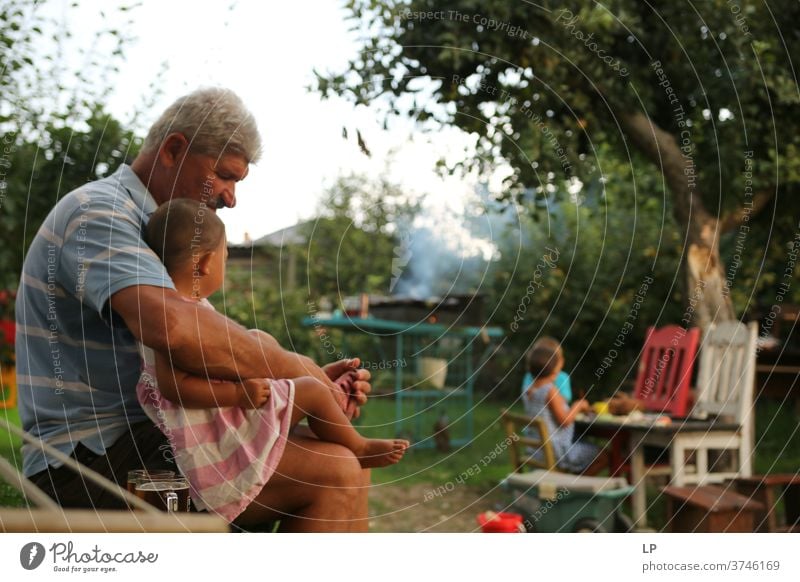 Grandpa holding small girl Looking away Downward Upper body Portrait photograph Exterior shot Colour photo Satisfaction Communicate Relationship Contentment