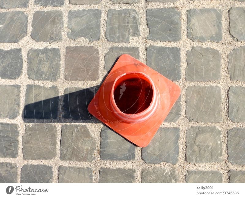 Pylon overlooking cobblestone streets... guiding cone Broken cobblestone pavement Ground Round Shadow Orange Stone square Vista Insight Street cordon