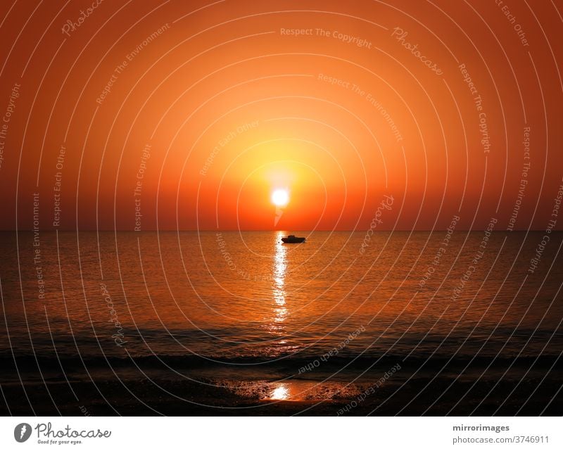 Sunrise sunset golden sun light sea horizon with motor boat silhouette shoreline sunset sea coastal landscape sunbeam enjoyment recreational boat tranquil scene