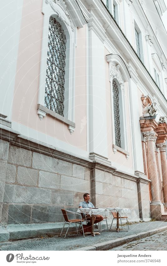 Man sitting in a sidewalk cafe Café Church Street sits Sit Adults Exterior shot Table Coffee Restaurant Easygoing person Drinking Sidewalk café Beverage Cup