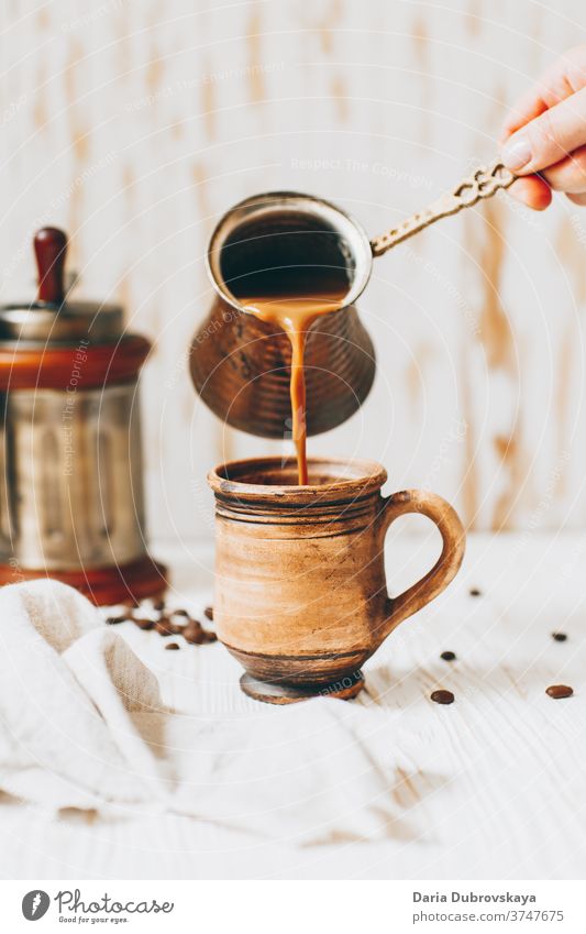 pouring coffee to cup, beans on a wooden background aroma breakfast cafe morning drink brown black dark beverage caffeine hot fresh roasted food natural arabica