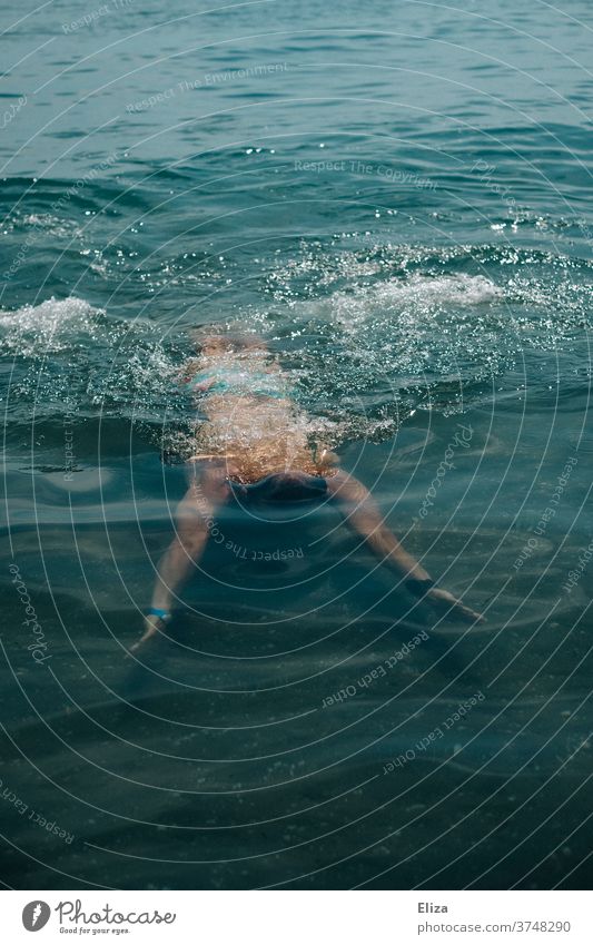 A man swimming and diving in the water be afloat Dive Water Man Ocean Lake Swimming & Bathing Summer cooling Human being bathing weather Blue Swimming train