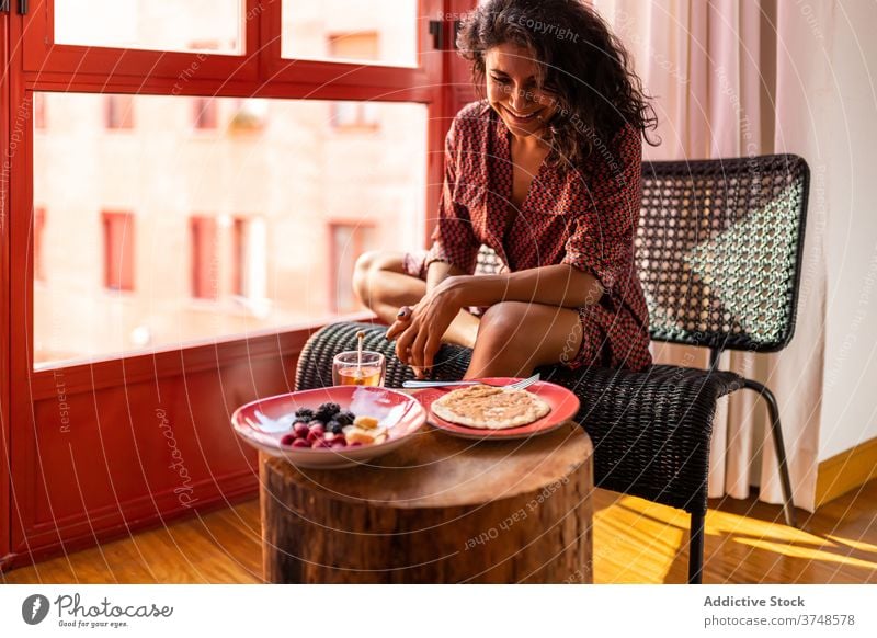 Woman eating healthy pancakes for breakfast plate smile sweet fresh tasty gastronomy fruit delicious raspberry honey organic food latin enjoy blueberry