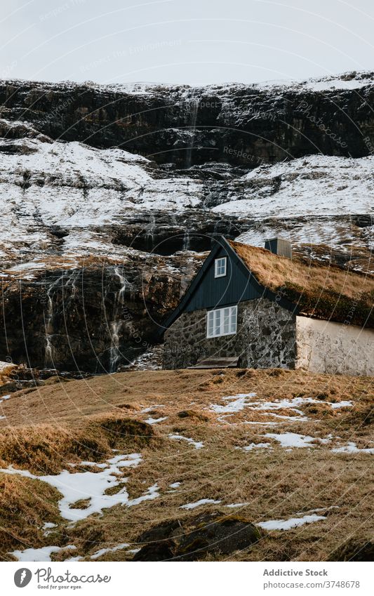 Wooden cottage on Faroe Islands on mountain village houses winter cold mountains nordic faroe islands travel coastal vacation famous place tourism