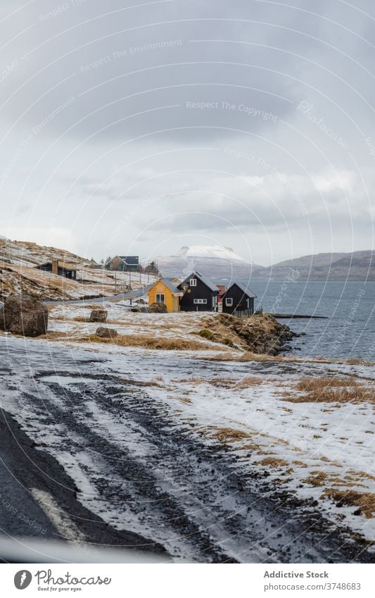 Small settlement in mountains on Faroe Islands village winter snow river season cold house residential faroe islands scenery breathtaking scenic countryside