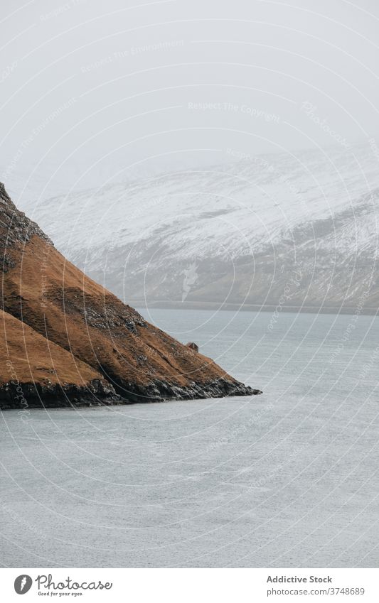 Small cabin wooden house in mountains on Faroe Islands village settlement winter snow river season cold residential faroe islands scenery breathtaking scenic