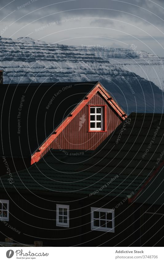 Wooden cottage on Faroe Islands on mountain village houses winter cold mountains nordic faroe islands travel coastal vacation famous place tourism