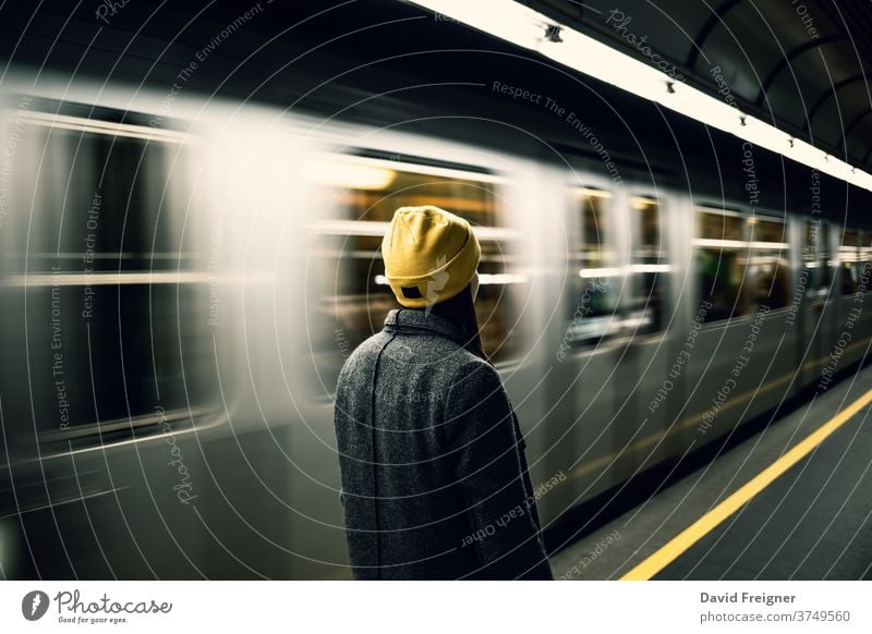 Young woman waits at the metro station while the train arrives. arrival subway city departure railroad commuter wagon fast light trip railway trail move