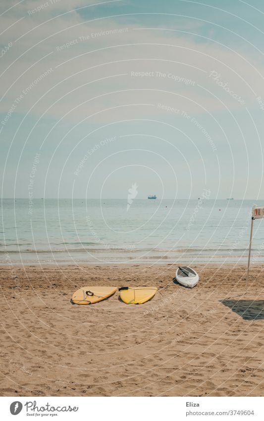 deserted beach with surfboards and a kayak Surfboards Beach Ocean Aquatics Empty vacation Sports Leisure and hobbies Surfing Summer Coast Sand Lifestyle