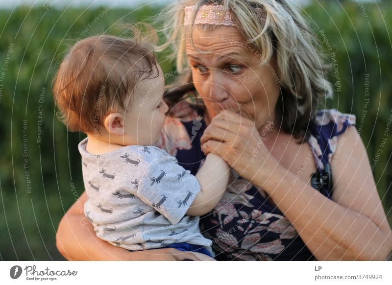 Grandma holding small child and kissing his hands Portrait photograph Love Hugs Truth Trust Joie de vivre (Vitality) Happiness Emotions Life Infancy Couple