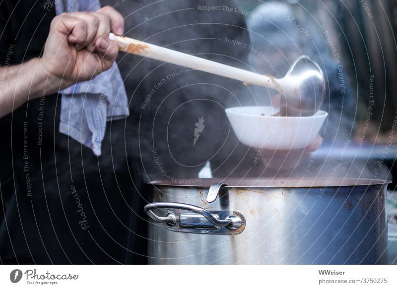 On a cold day delicious steaming soup is served Soup Hot Pot ladle Ladle Towel bar pour Delicious warm Help hardship hunger Eating bowl Portion Tramp