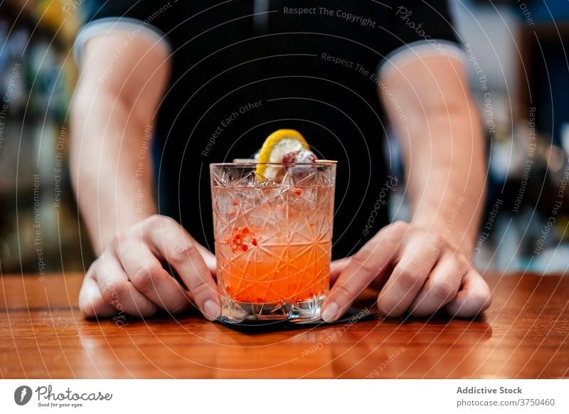 Crop barman preparing cocktail in bar bartender alcohol prepare beverage ice counter male professional cold service occupation refreshment job restaurant drink