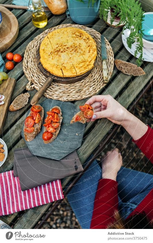 Crop women at table with food in forest picnic together eat various woods delicious valle del jerte caceres spain tasty wooden meal friend lunch vacation snack