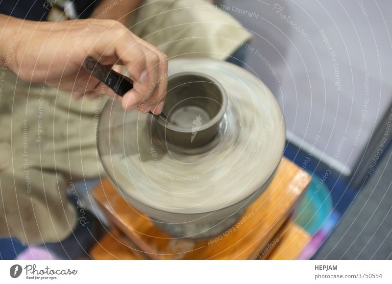 Concept Ceramic workshop. The man Throwing clay bowl on a pottery's wheel. art artisan banner ceramic circle concept cover design craft craftsman craftsperson