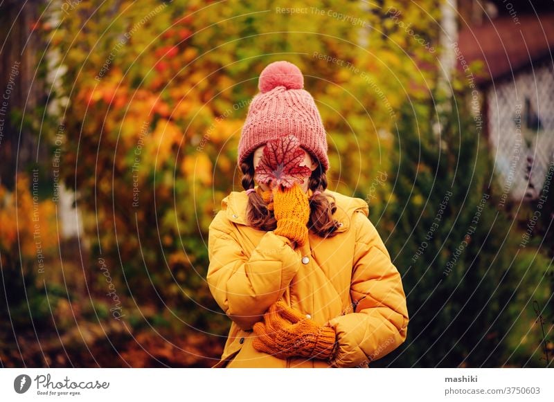 cute kid girl walking in autumn garden or park, wearing warm stylish clothes child season fun nature outdoor joy happy childhood gardening leaf outside playing