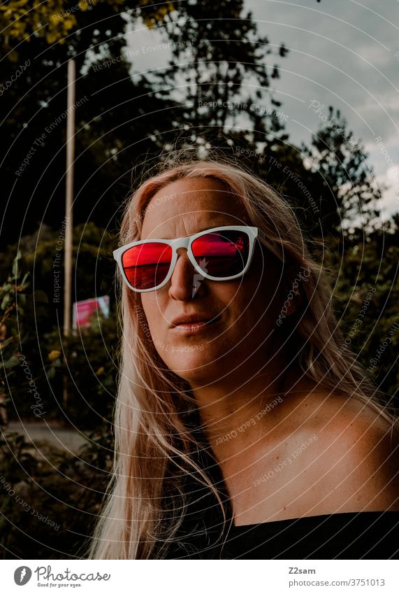 Young woman relaxing by the lake be afloat Lake Beach way Summer Sun sunglasses Blonde Athletic Easygoing Cool teen youthful Swimming & Bathing pretty