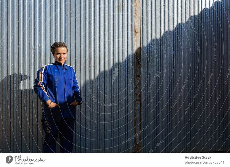 Smiling woman in workwear on farm worker uniform building rural smile sunlight metal wall female stand cheerful employee positive friendly joy occupation