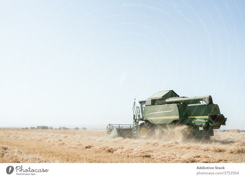 Agricultural machine in filed in summer harvest combine collect field wheat countryside machinery farm agriculture season rural nature meadow farmland