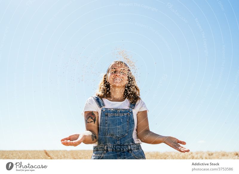 Cheerful woman with wheat grain in field countryside village agriculture toss cheerful cereal female summer meadow idyllic season cultivate sunny plant happy