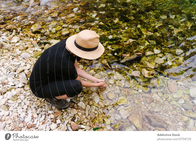 Traveling woman drinking water from river traveler adventure forest clear enjoy refreshment female calm tourist vacation summer nature tranquil relax tourism