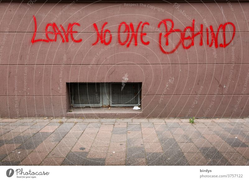 Leave No One Behind, sprayed writing on a house wall. refugees, migrants, disadvantaged, humanity Refugee leave no one behind Migration Humanity Moria Migrants