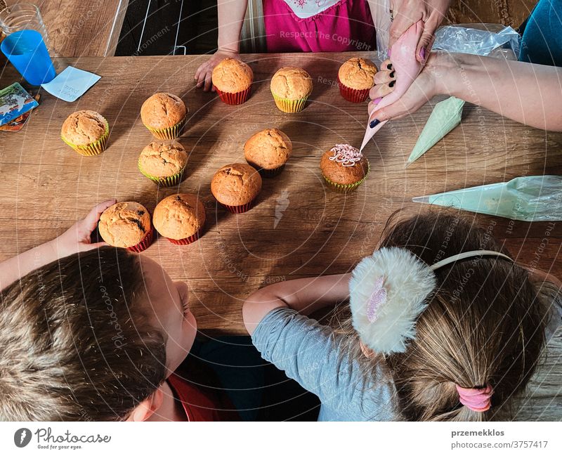 Children baking cupcakes, preparing ingredients, decorating cookies children cooking bake family domestic muffin together childhood happy little kid kitchen