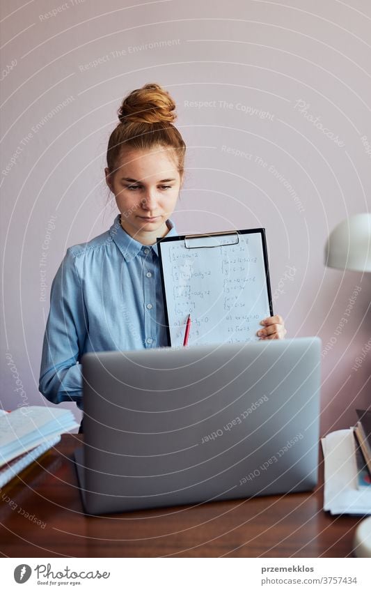 Student learning online, watching lesson remotely, listening to professor, talking with classmates on video call from home during quarantine accessories bed