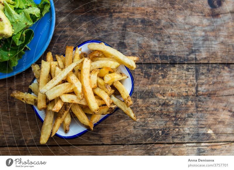 French Fries with Avocado and Mustard Salad fries french potato chips avocado salad leaves food yellow snack fast fry wooden golden eat meal delicious tasty