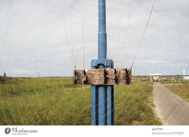 Partial view of flagpole with rope attachment North Sea Island Wangerooge port area Flagpole Blue Grass Mounting option Wood ropes Knot Tighten Nostalgia