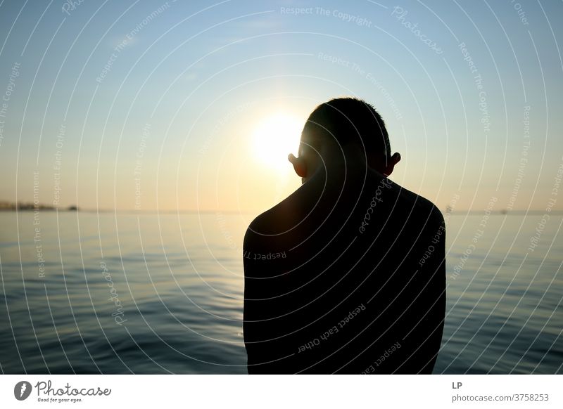 contrast silhouette of a child against sea and sky Contrast Shallow depth of field Silhouette Shadow Light Day Exterior shot Action Body Boy (child) Human being