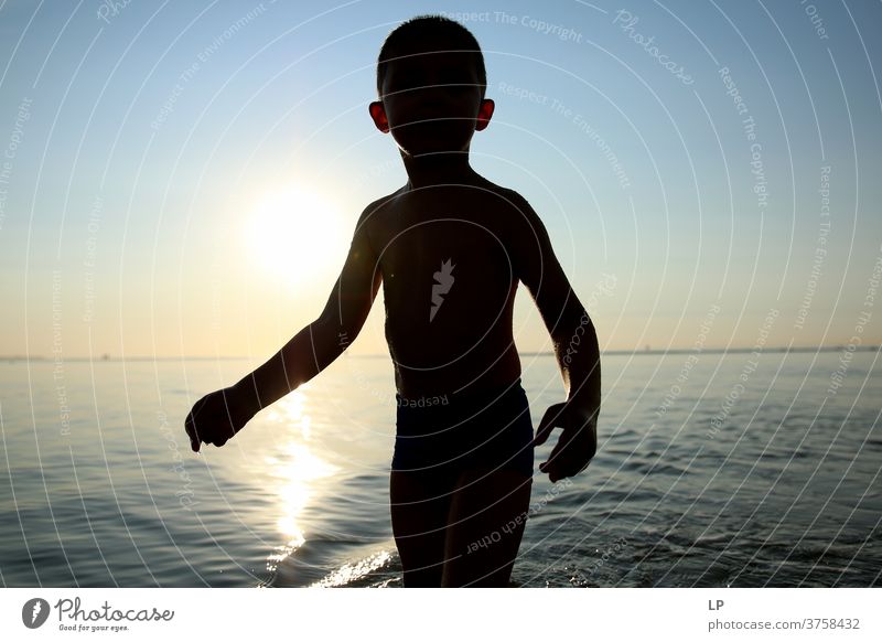 contrast silhouette of a child against sea and sky Contrast Shallow depth of field Silhouette Shadow Light Day Exterior shot Action Body Boy (child) Human being