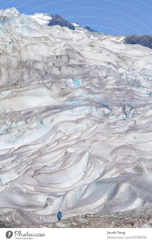 Two people looking up at a glacier Glacier global warming ice melting snow Crevice Hiking outdoors Nature portrait Summer Blue National Park backkpacking