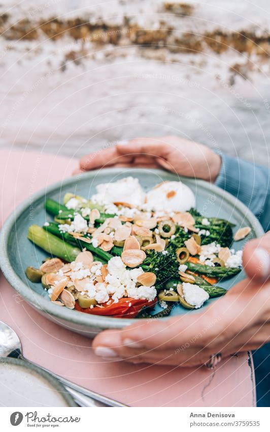 Healthy Breakfast with poached eggs Brunch Trendy Cafe roasted red pepper tenderstem broccoli asparagus romesco sauce olives toasted almonds feta many plates