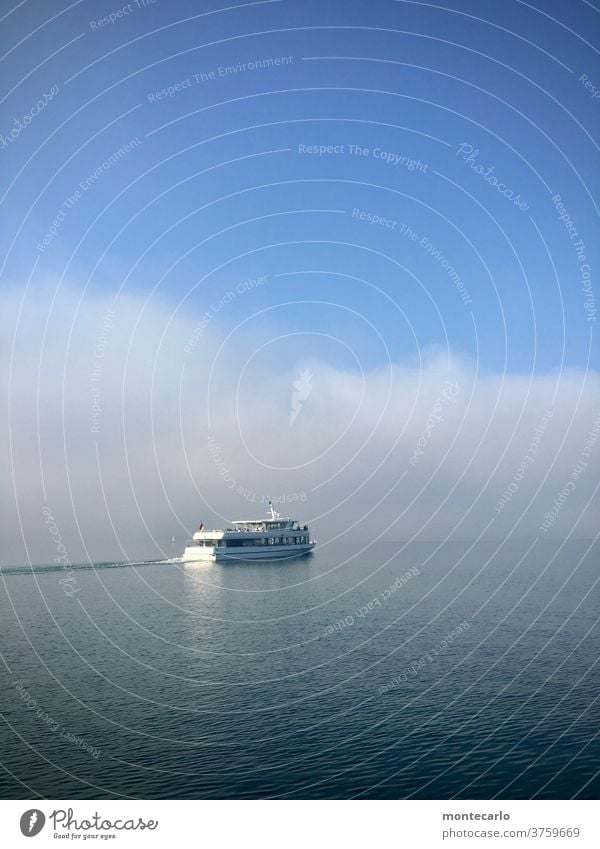 Passenger ship on Lake Constance in front of a wall of fog in autumn wide Sunlight Beautiful weather Vantage point Environment experience Überlingen Trip