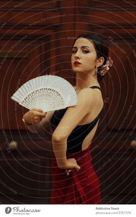 Elegant woman with fan performing Flamenco dance flamenco dancer tradition passion elegant grace hispanic female young sensual style ethnic art artist move