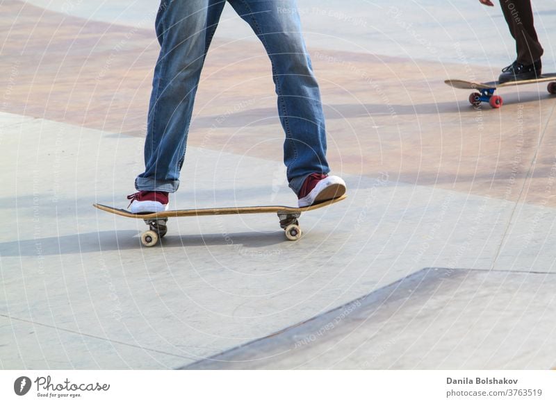 Young man practising on skateboard in skate park action active athlete athletic boarding boy casual contest culture deck dynamic energy extreme extreme sports