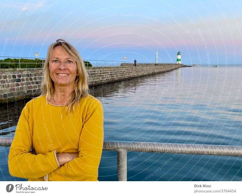 Smiling woman on the pilot island Schleimünde / Schleswig-Holstein Woman 45 - 60 years Lighthouse Adults portrait Blonde already Human being Baltic Sea wide