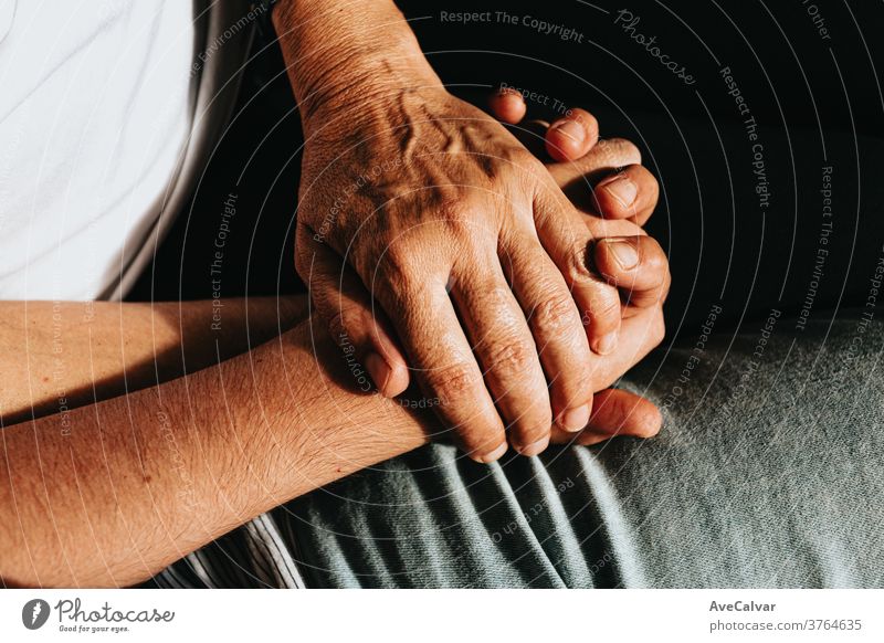 Close up of two old hands grabbing a young hand on cinematic tones assistance community females friendship grandparent holding hands horizontal reaching