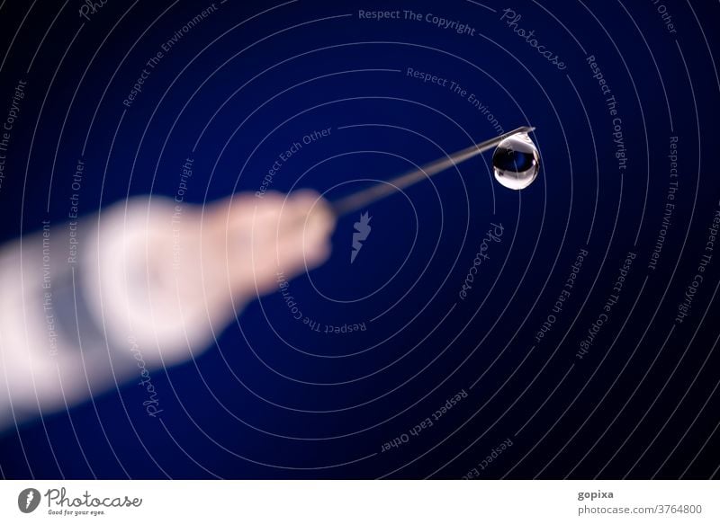 Close-up of a cannula with drops and syringe needle Drop Syringe Cannula medicine Immunization stodgy Doping Medication Active substance Pharmaceutics