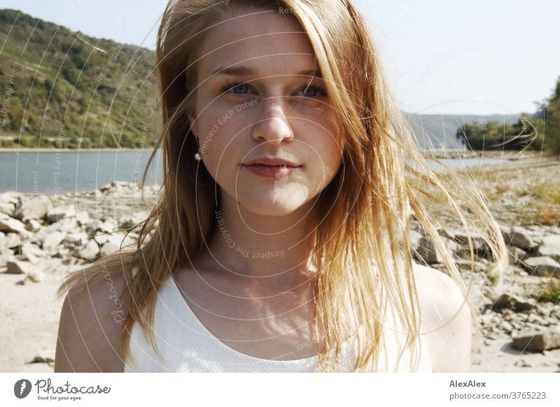 Close up backlight portrait of a young, freckled woman with wind-blown hair on the banks of the Rhine Woman Young woman Slim already athletic Blonde youthful