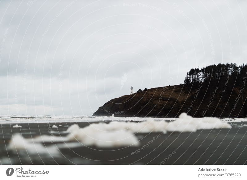 Scenery of hill near sea on cloudy day foam beach gloomy seascape scenery gray sky usa america united states landscape nature water idyllic coast freedom serene