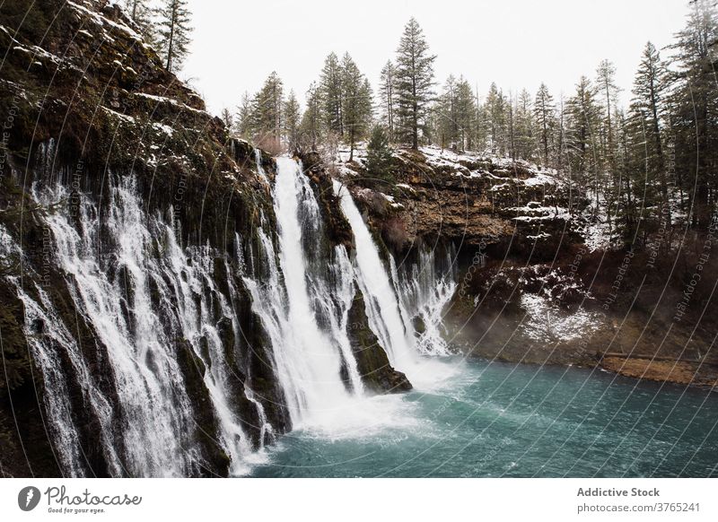 Waterfall in snowy mountainous forest in winter day waterfall flow nature landscape pool cold stream scenic picturesque scenery travel tourism usa united states