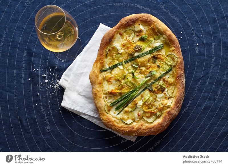 Top view of vegetarian pizza zucchini onion blue orange wine cheese crust salt italian cuisine food meal flatlay top view overhead zucchini flowers rustic