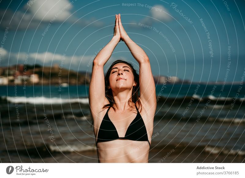 Tranquil woman in bikini at seaside enjoy vacation summer carefree cheerful seashore sunny female water clear resort nature rest freedom holiday calm sky happy