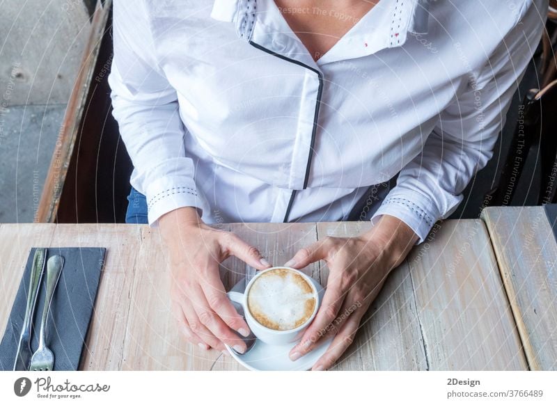 Young blonde woman drinking coffee in cafe person sitting cup female lifestyle table smiling business girl young indoor happy adult beautiful smile one person