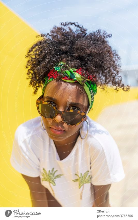 Attractive young african american woman with sunglasses and headband afro hair 1 black fashionable female hairstyle curly lady person beautiful girl beauty