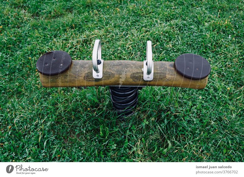 old wooden seesaw on the playground playing playtime playful fun park public park street outdoors childhood Funny joy little lifestyle cheerful happiness